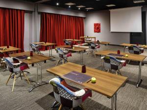 a classroom with tables and chairs with tennis balls on them at ibis Southampton in Southampton