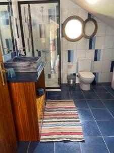 a bathroom with a sink and a toilet and a mirror at Yellow Attic in Senhora do Rosário +8 photos