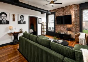 a living room with a couch and a brick wall at Best Intentions in Port Clinton