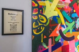 a picture of a painting next to a picture frame at MM Suites Town House Terrasse in Reims +73 photos
