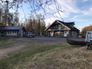 a house with a boat parked in front of it at Arctic Camping Finland in Pello