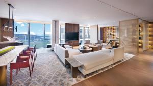 a living room with white furniture and a large window at Crowne Plaza Shenzhen World Exhibition and Convention Center by IHG in Shenzhen