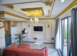 a living room with a couch and a table at EYLA VİLLA in Trabzon
