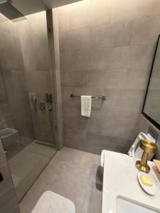 a bathroom with a shower and a sink at Fontana infinity in Manama