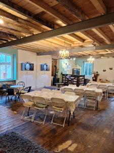 a large room with tables and chairs in it at Gite Les Eylauds in Pionsat