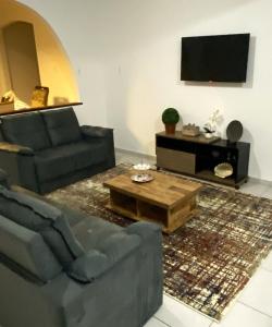 a living room with a couch and a coffee table at RCM Vilas - Casa Confortável 02 in Joinville