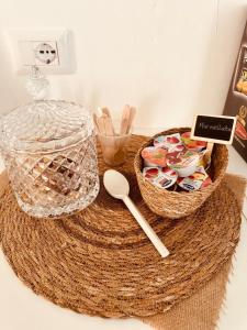 a table with two baskets of tooth brushes and a spoon at Grey House Guest House Luxury in Latina