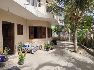 a courtyard of a house with a palm tree at Barros Homestay in Tarrafal