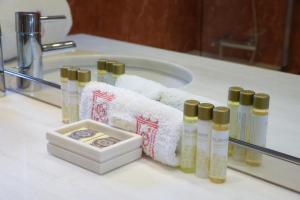 a bathroom counter with several bottles of soap and towels at Hotel Rural Quinta Do Pego in Tabuaço +53 photos