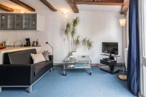 a living room with a couch and a tv at Anny's Warehouse City Centre! in Amsterdam