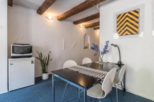 a kitchen with a table and chairs and a refrigerator at Anny's Warehouse City Centre! in Amsterdam +20 photos