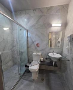 a bathroom with a toilet and a sink and a shower at Villa Preveza Apartments in Preveza +21 photos