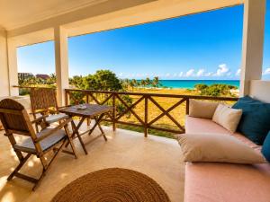 a living room with a view of the ocean at Raffia Boutique Hotel in Jambiani