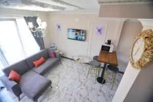 a living room with a couch and a table at EYLA VİLLA in Trabzon