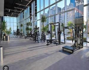 a gym with rows of exercise equipment in a building at Fontana infinity in Manama