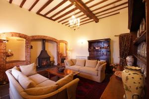 a living room with two couches and a fireplace at Ffermdy Clwyd in St Asaph