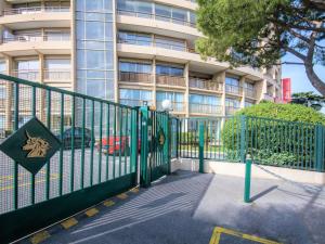 a green fence in front of a building at ibis Cannes Plage La Bocca in Cannes