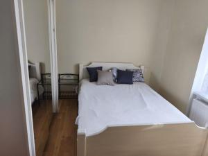 a white bed with pillows on it in a room at Maison Relax in Flers