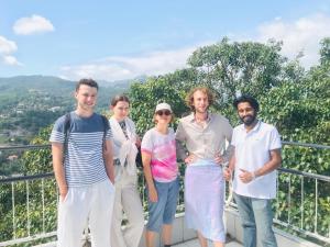 a group of people posing for a picture on a balcony at Sapphire Homestay in Palle Deltota +1 photo