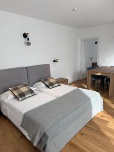 a bedroom with a large bed and a table at Condhotel Fanti Ski & Bike in Valdisotto