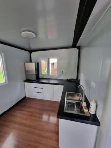 a small kitchen with a counter with a laptop on it at MAZI HOUSE Jastarnia in Jastarnia