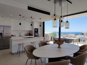 a kitchen and dining room with a table and chairs at Higuerón 5821 in Málaga