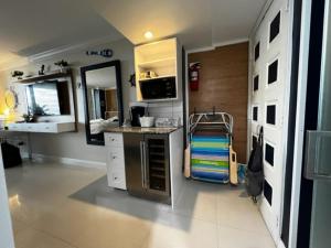 a small kitchen with a counter and a sink at Ocean Manor Tiki Sunset Retreat in Fort Lauderdale