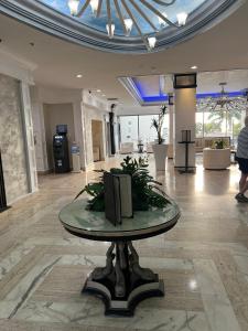 a lobby with a glass table with a tv on it at Ocean Manor Tiki Sunset Retreat in Fort Lauderdale +66 photos