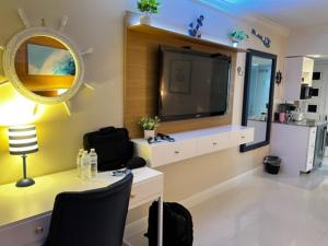 a room with a vanity with a mirror and a tv at Ocean Manor Tiki Sunset Retreat in Fort Lauderdale