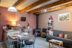 a living room with a table and a couch at La forge 2/5 personnes in Saint-Pierre-de-Nogaret