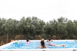 a group of people in a swimming pool at Kandia Woodlands in Kandia