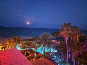 a view of the beach and the ocean at night at Ocean Manor Tiki Sunset Retreat in Fort Lauderdale