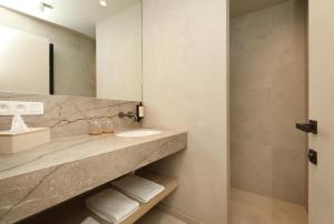 a bathroom with a sink and a mirror at Spacious Luxury Lodge for 8 – Woodz Lodges Heusden-Zolder in Heusden - Zolder