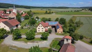 an aerial view of a village with houses and a church at Ferienwohnung Kleine Auszeit in Bastheim
