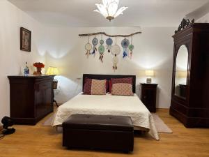 a bedroom with a bed with a ottoman in it at L’Angelina in Martrin