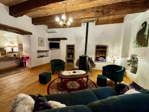 a living room with a couch and a table at L’Angelina in Martrin