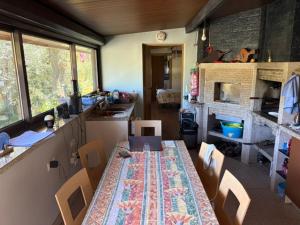 a kitchen with a table and chairs in a room at SENRa in Marco de Canaveses