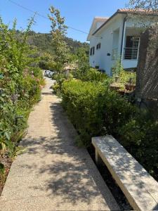 a path with a bench next to a house at SENRa in Marco de Canaveses