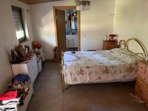 a bedroom with a bed with a floral comforter on it at SENRa in Marco de Canaveses