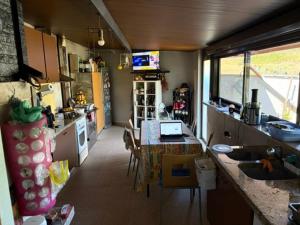 a kitchen with a table with a laptop on it at SENRa in Marco de Canaveses