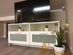 a white entertainment center with a flat screen tv on top at Dimore Angye in Termoli