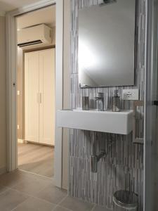 a bathroom with a white sink in a room at Dimore Angye in Termoli +51 photos