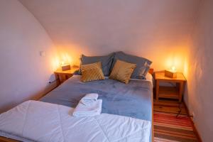 a bedroom with a bed with two nightstands and two lamps at Gîte agnès 2/3 personnes in Laval-du-Tarn