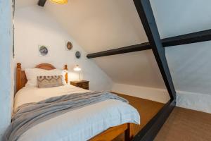 a bedroom with a bed in a attic at Trespaddick, coastal views Treworgie Barton in Bude
