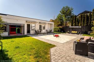 a house with a patio and a yard at LOFT ROOMS ŁEBA in Łeba