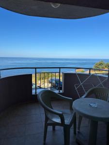 a balcony with a table and chairs and the ocean at стаи за гости Гергана in Tsarevo