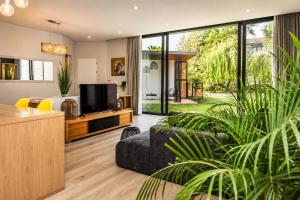 a living room with a tv and a large window at 4 Lulworth in Johannesburg