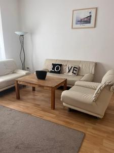 a living room with a couch and a coffee table at Ferienwohnung Spremberg-City III in Spremberg