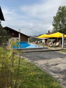 a house with a swimming pool next to a building at Ferienwohnung WAUzenberg mit Pool und Sauna in Hauzenberg