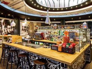 a bar in a restaurant with stools and a counter at ibis Birmingham Centre New Street Station Hotel in Birmingham